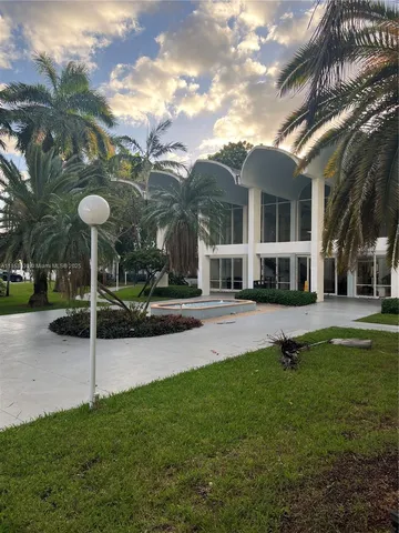 a view of a house with a backyard porch and sitting area