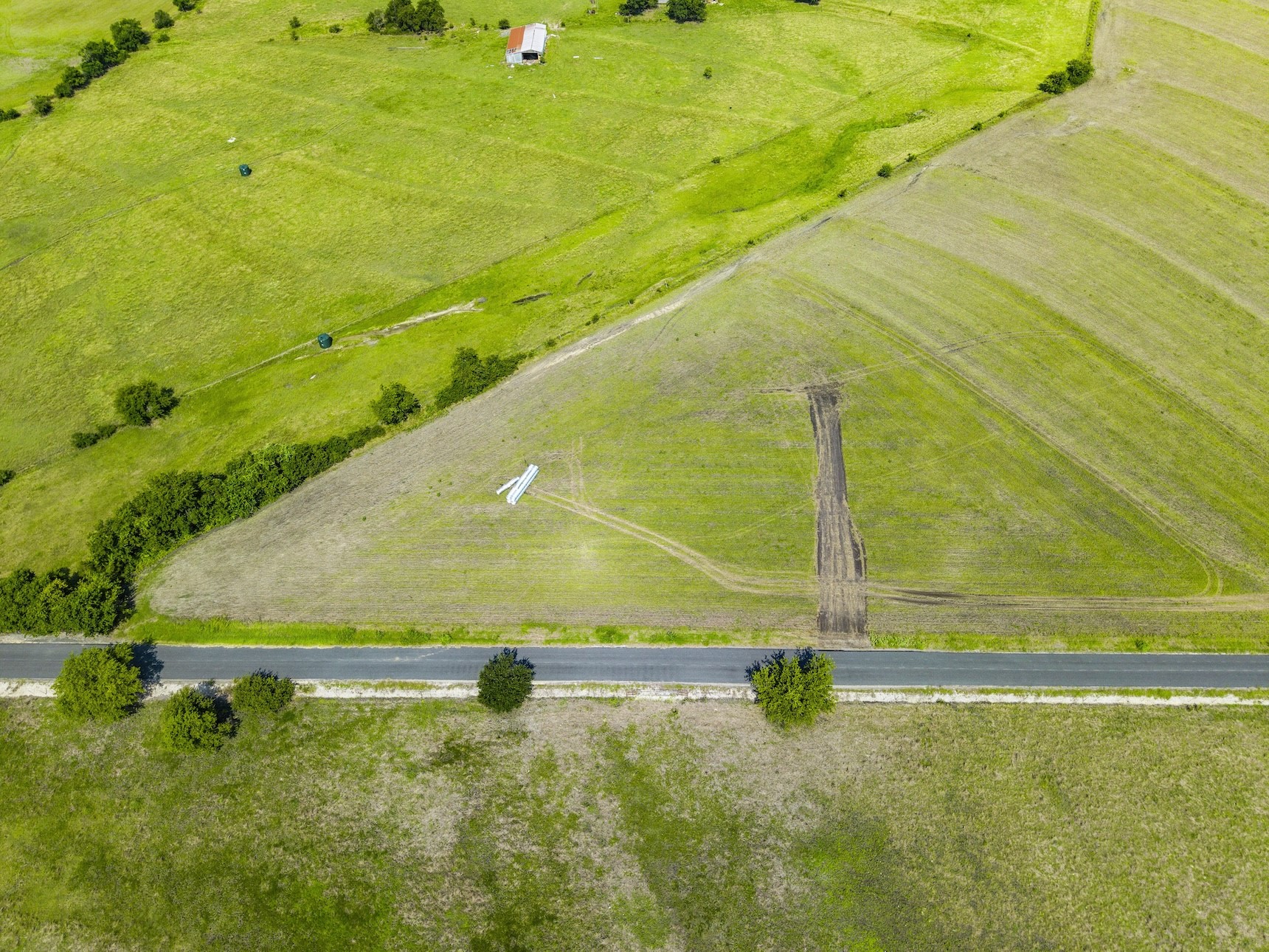 1 County Road 327 Road Granger, TX 76530 - Photo 2 of 27 Vast green pastures and open acreage sit adjacent to a paved road.