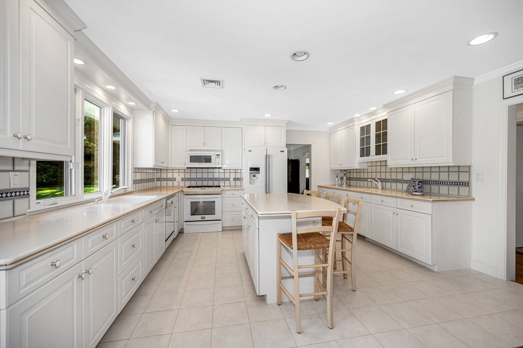 246 Highland Road Andover, MA 01810 - Photo 5 of 42 a large kitchen with white cabinets and white stainless steel appliances