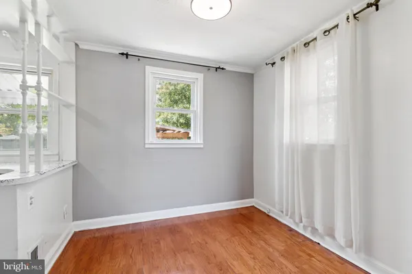 a view of a room with a window and wooden floor