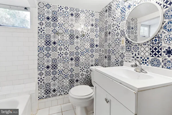 a bathroom with a sink toilet and a mirror