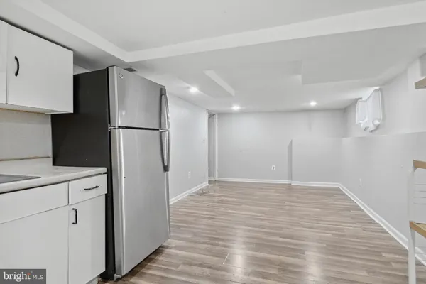 a view of a kitchen with a sink and a refrigerator