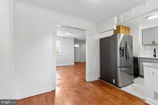 a metallic refrigerator freezer sitting in a kitchen