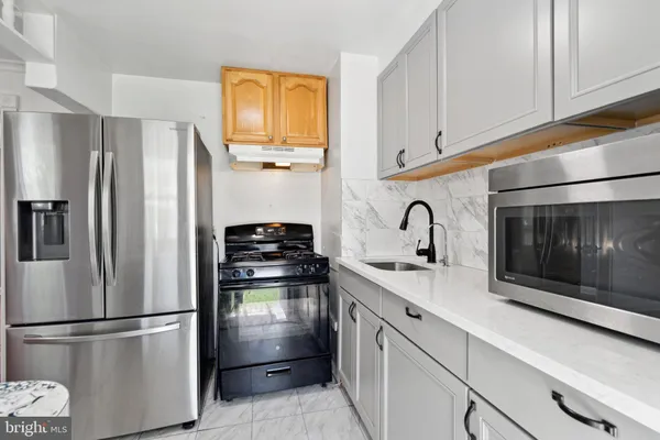 a kitchen with stainless steel appliances a refrigerator sink and cabinets