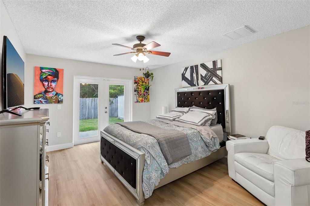 1525 Kestrel Way Brandon, FL 33511 - Photo 16 of 48 a bedroom with a bed and a chandelier