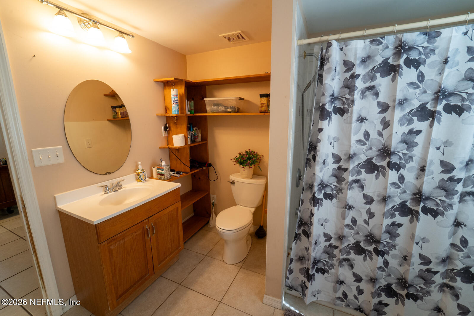 5308 North River Road Jacksonville, FL 32211 - Photo 15 of 25 a bathroom with a toilet sink and mirror