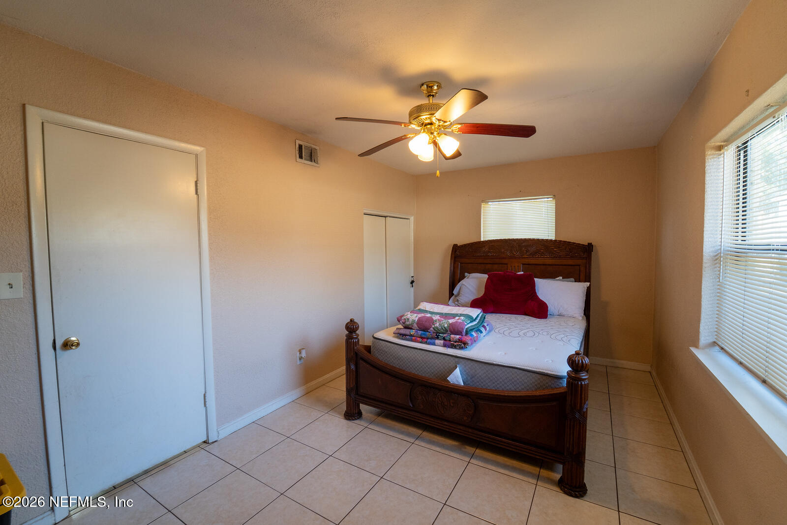 5308 North River Road Jacksonville, FL 32211 - Photo 21 of 25 a bedroom with a bed and a chandelier