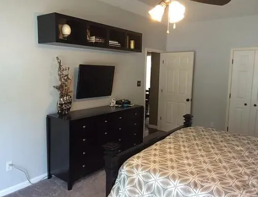 a bedroom with a bed and a wall painting