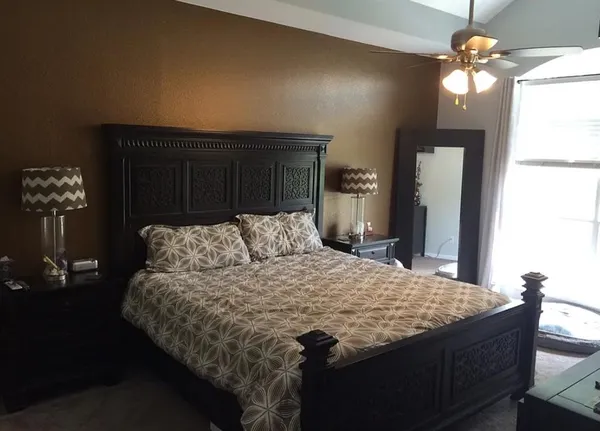a bed sitting in a bedroom and wooden floor