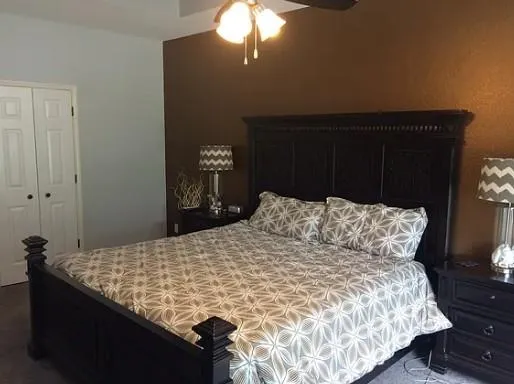 a bedroom with a bed and a television