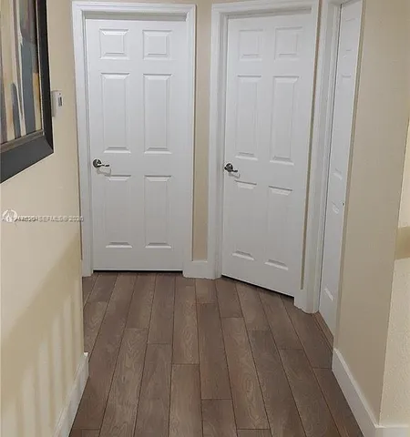 a view of a room with wooden floor