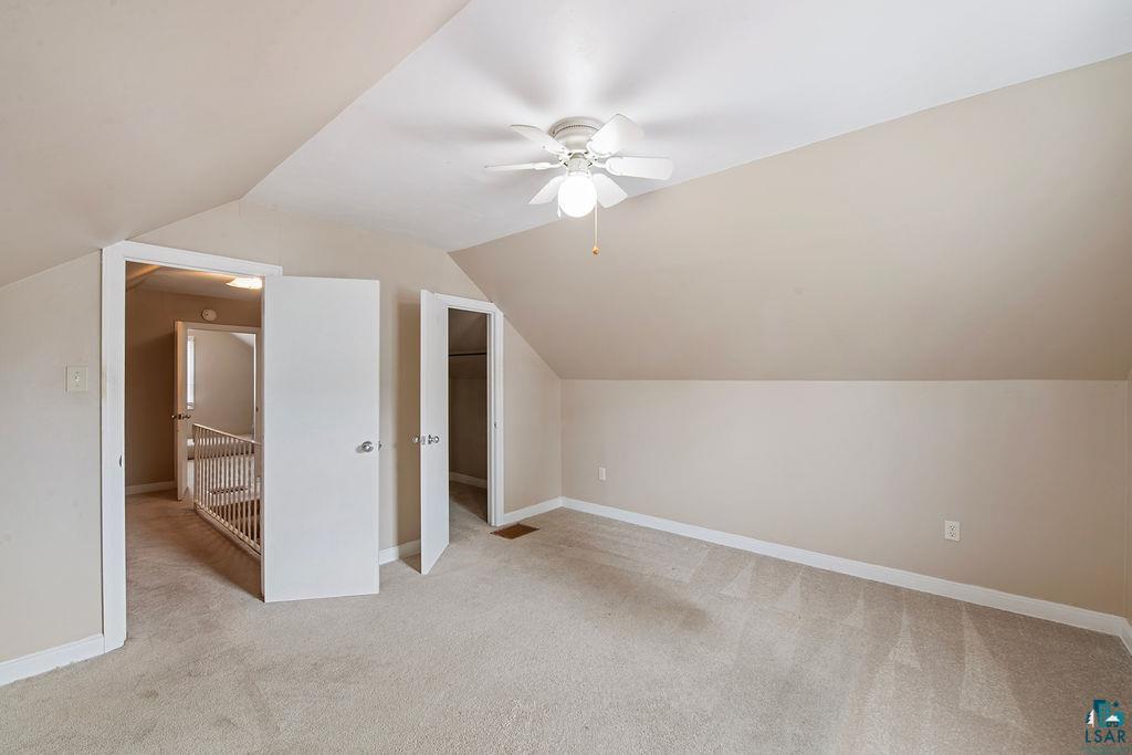122 3rd Street Cloquet, MN 55720 - Photo 11 of 42 Carpeted room featuring an angled ceiling and neutral wall tones