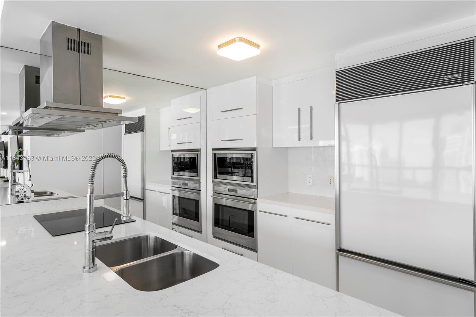 495 Brickell Avenue, Unit 3804 Miami, FL 33131 - Photo 4 of 23 a kitchen with granite countertop a sink and a refrigerator
