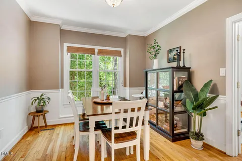a view of a dining room with furniture a chandelier and wooden floor