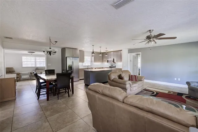 a living room with furniture and kitchen view