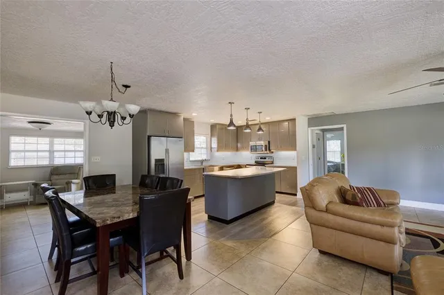 a living room with a couch and chandelier