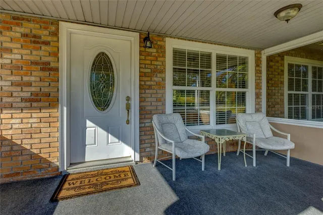 a view of a chairs and table in a balcony