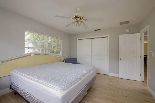 a bedroom with a large bed and a chandelier