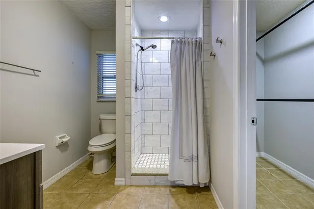 a bathroom with a toilet a sink and shower