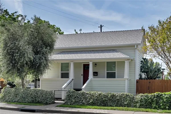 front view of house with potted plants