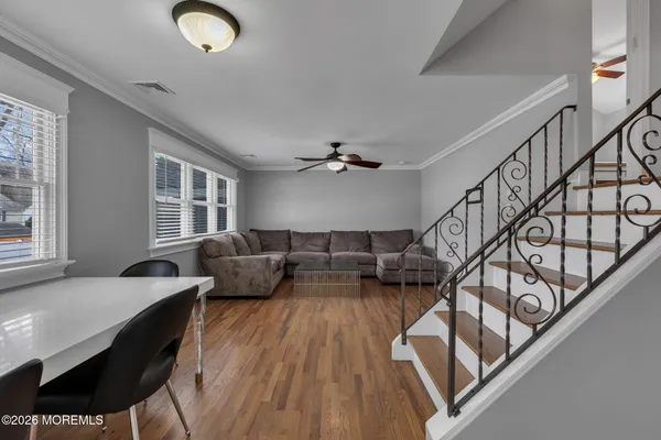 a living room with furniture and wooden floor