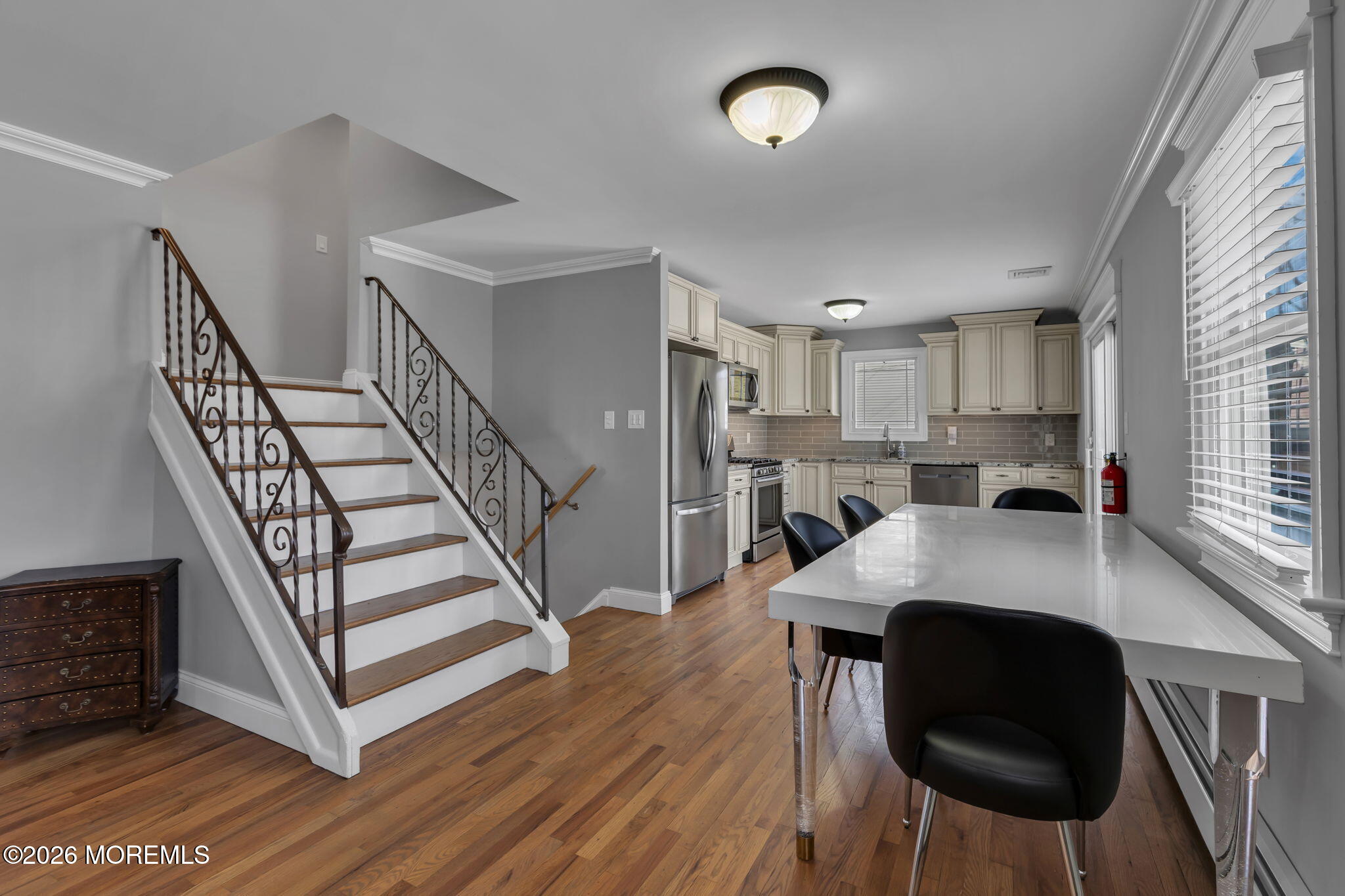 27 Branch Road Oakhurst, NJ 07755 - Photo 16 of 44 a view of kitchen island with furniture and wooden floor