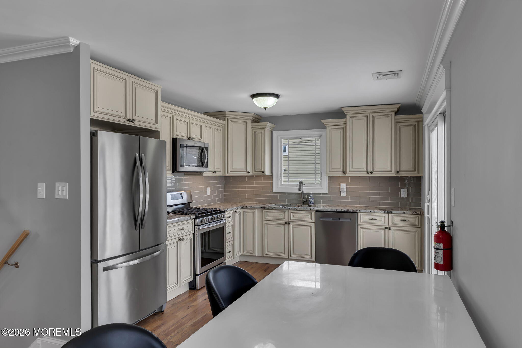 27 Branch Road Oakhurst, NJ 07755 - Photo 18 of 44 a kitchen with stainless steel appliances a refrigerator sink and cabinets