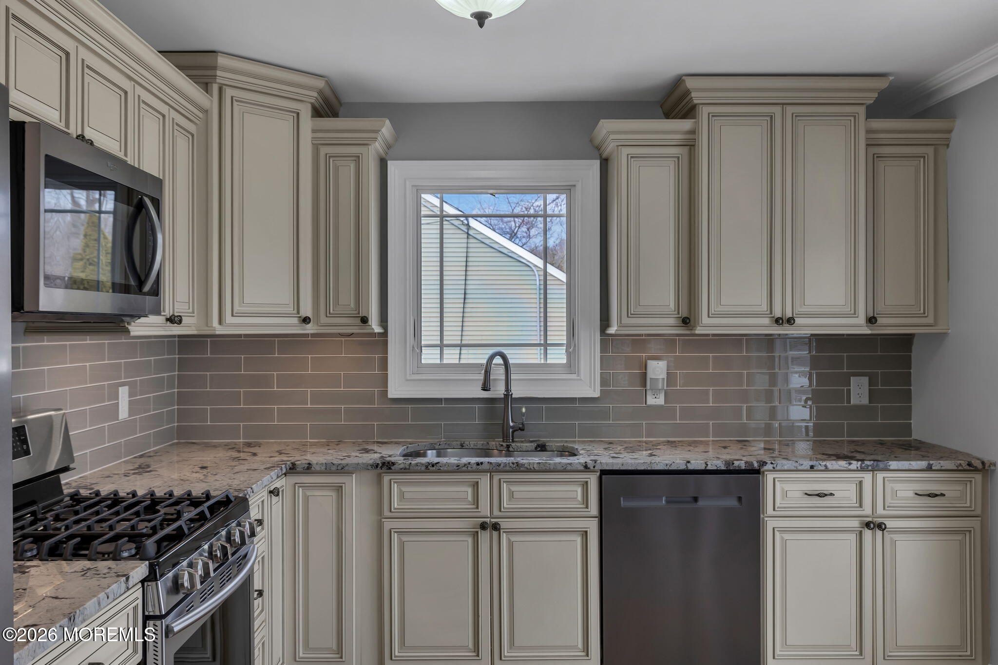 27 Branch Road Oakhurst, NJ 07755 - Photo 19 of 44 a kitchen with stainless steel appliances granite countertop a sink stove and cabinets