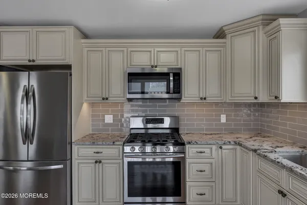 a kitchen with cabinets stainless steel appliances and a sink