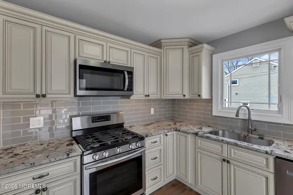 a kitchen with cabinets stainless steel appliances a sink and a counter space