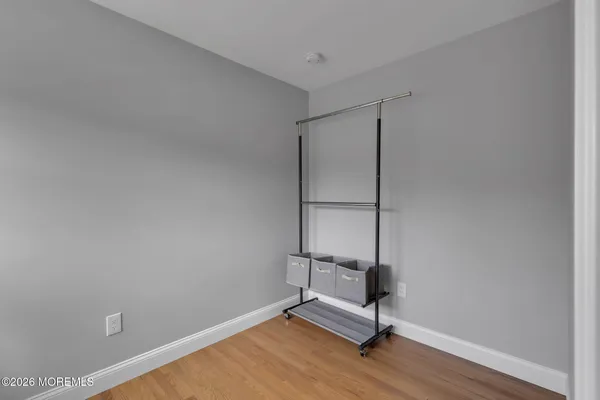 a view of a room with wooden floor