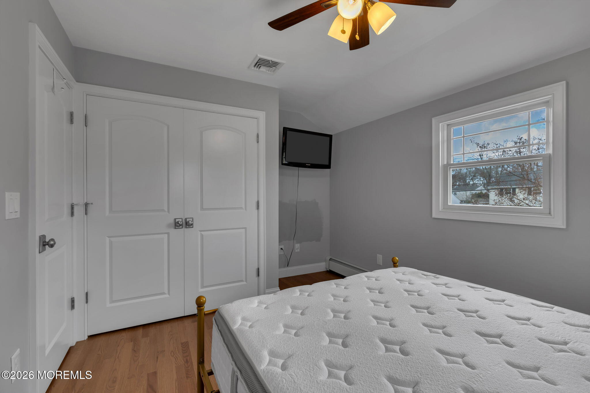 27 Branch Road Oakhurst, NJ 07755 - Photo 32 of 44 a bedroom with a bed and a chandelier