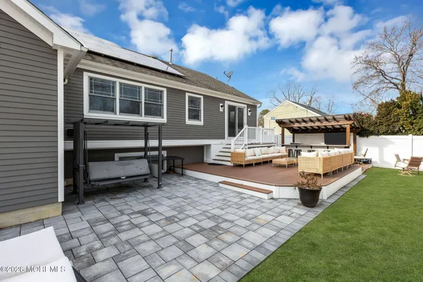 a swimming pool with outdoor seating and yard