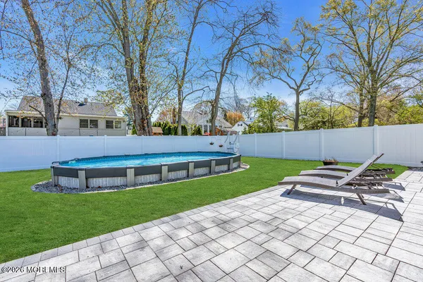 a view of house with backyard and outdoor seating