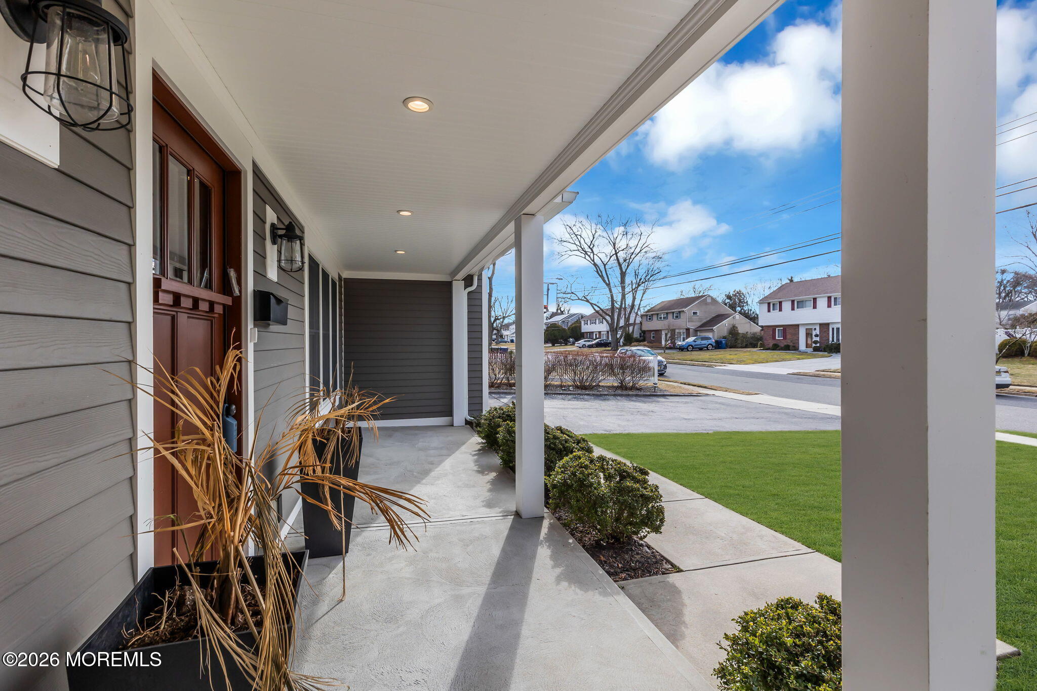 27 Branch Road Oakhurst, NJ 07755 - Photo 6 of 44 a porch with a table and chairs