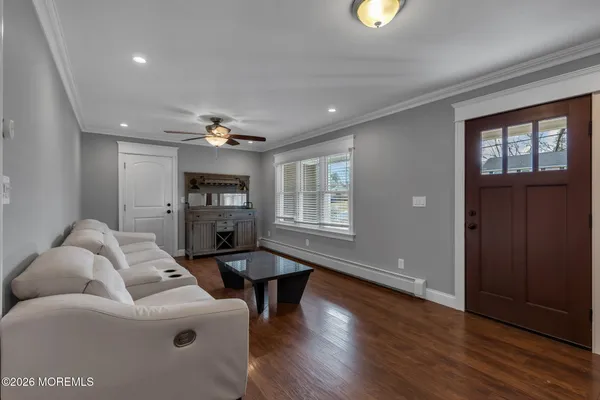 a living room with furniture and wooden floor