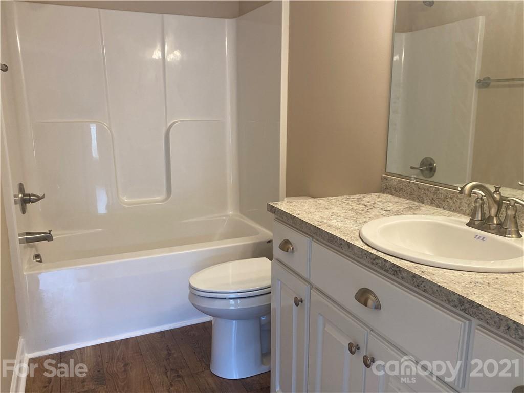 1505 Foxbrook Circle Lancaster, SC 29720 - Photo 4 of 7 a bathroom with a granite countertop sink a toilet and bathtub