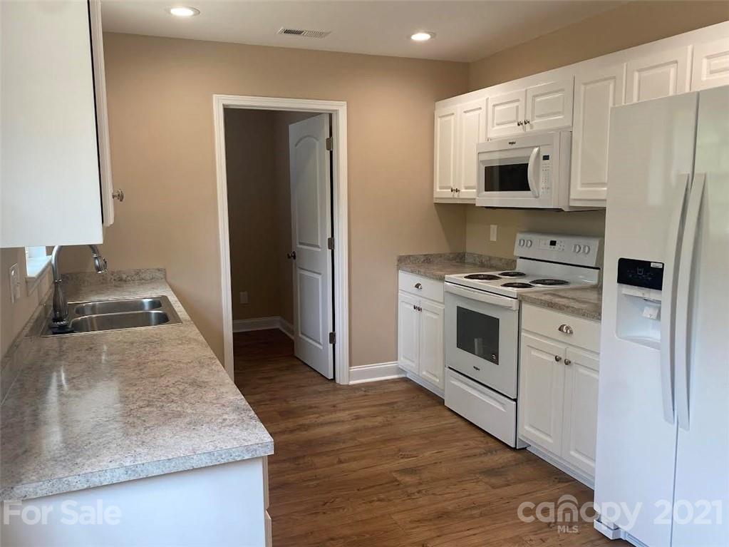 1505 Foxbrook Circle Lancaster, SC 29720 - Photo 6 of 7 a kitchen with stainless steel appliances granite countertop a stove a refrigerator and a microwave