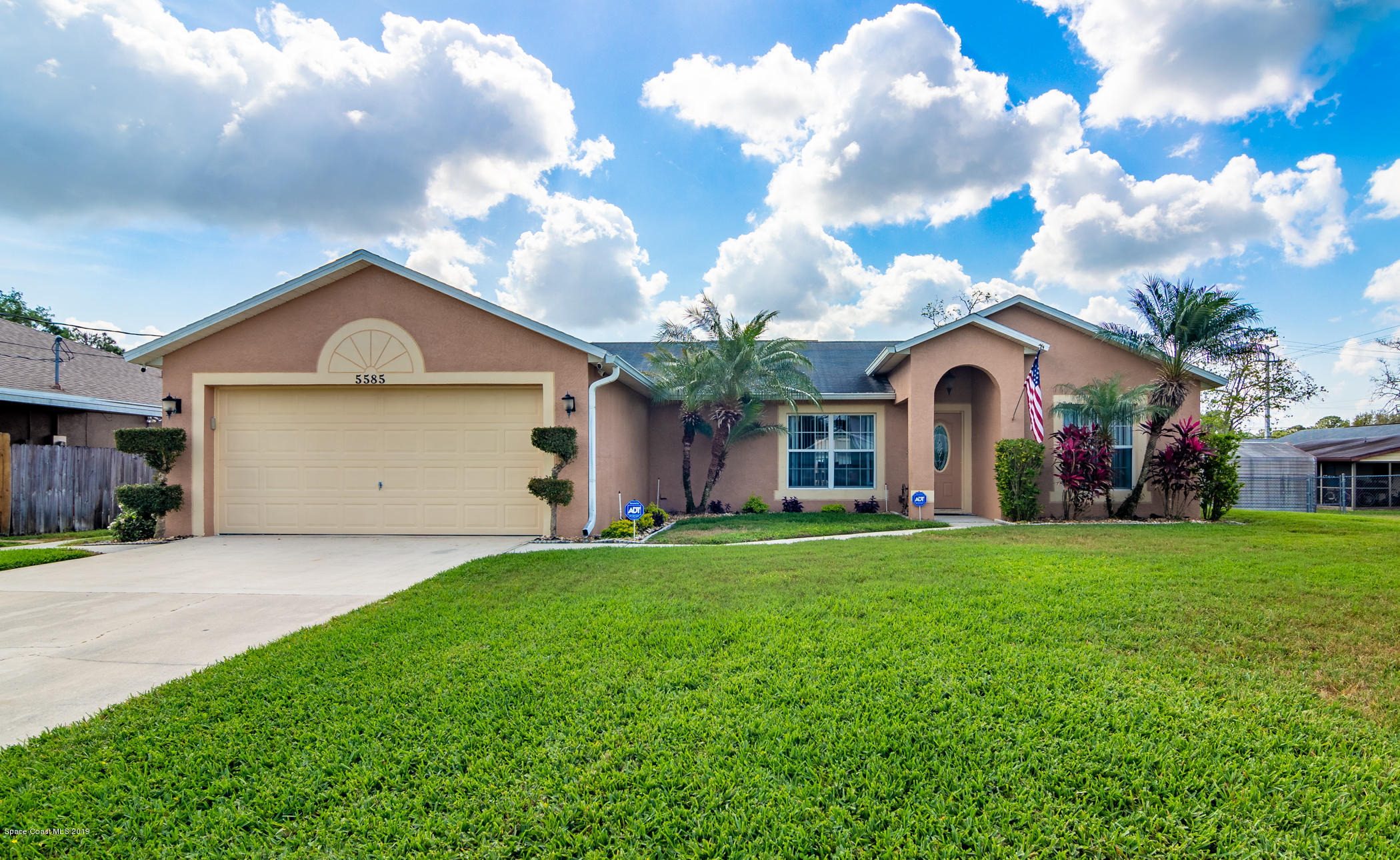5585 Flint Road Cocoa, FL 32927 - Photo 1 of 14 a front view of a house with a yard and garage