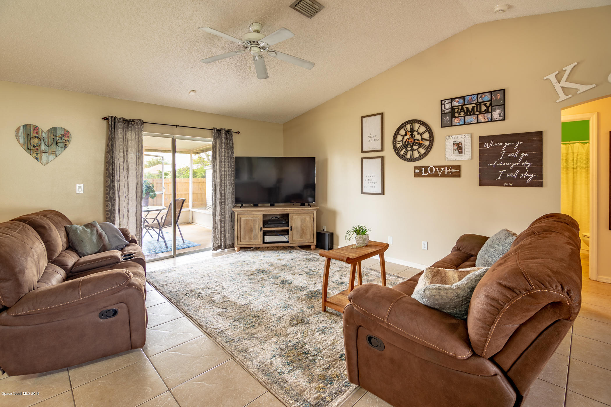 5585 Flint Road Cocoa, FL 32927 - Photo 3 of 14 a living room with furniture and a flat screen tv