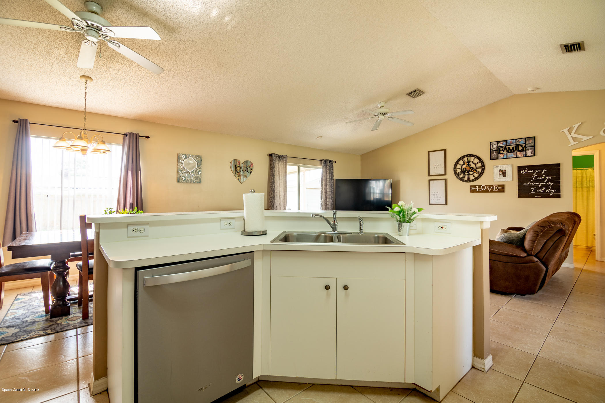 5585 Flint Road Cocoa, FL 32927 - Photo 4 of 14 a kitchen with stainless steel appliances granite countertop a sink and cabinets