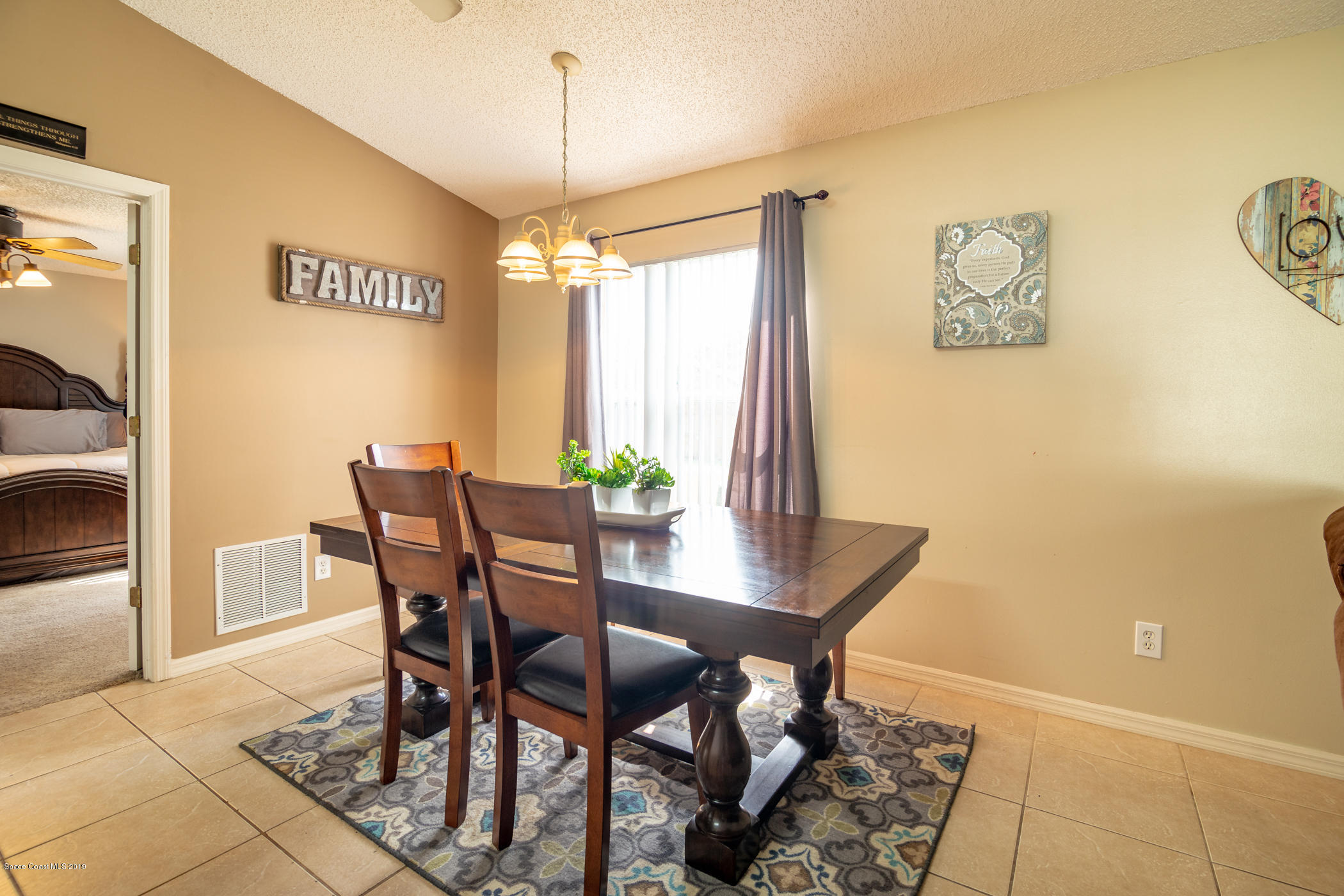 5585 Flint Road Cocoa, FL 32927 - Photo 6 of 14 a view of a dining room with furniture and a chandelier