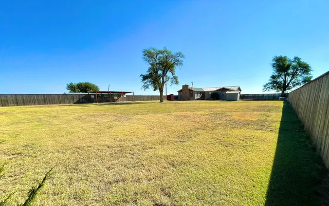a view of a swimming pool with a yard