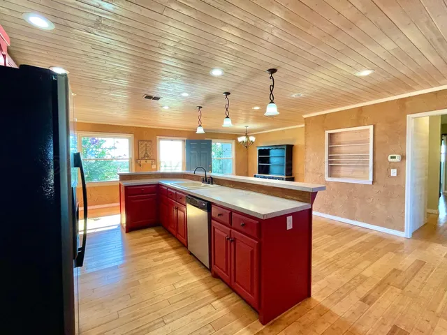 a kitchen with stainless steel appliances granite countertop a stove a sink and a refrigerator