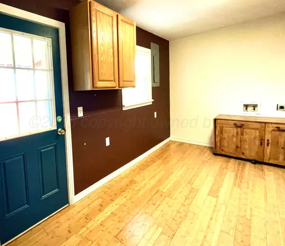 a view of a room with wooden floor