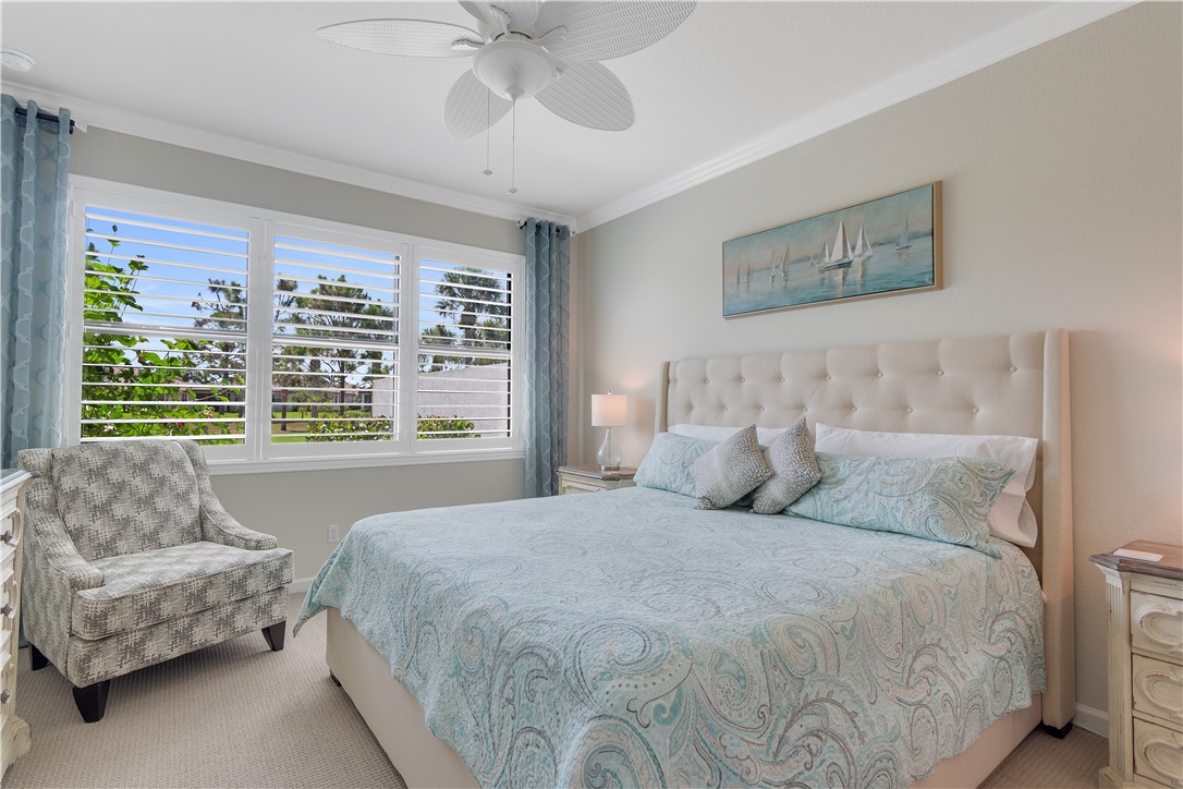 5122 Unity Square Vero Beach, FL 32967 - Photo 15 of 33 a bedroom with a large bed and a couch