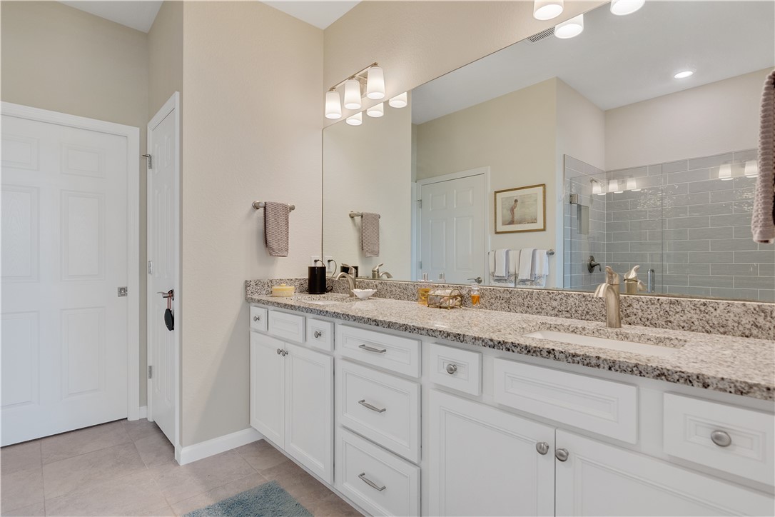 5122 Unity Square Vero Beach, FL 32967 - Photo 16 of 33 a bathroom with double sink and a mirror