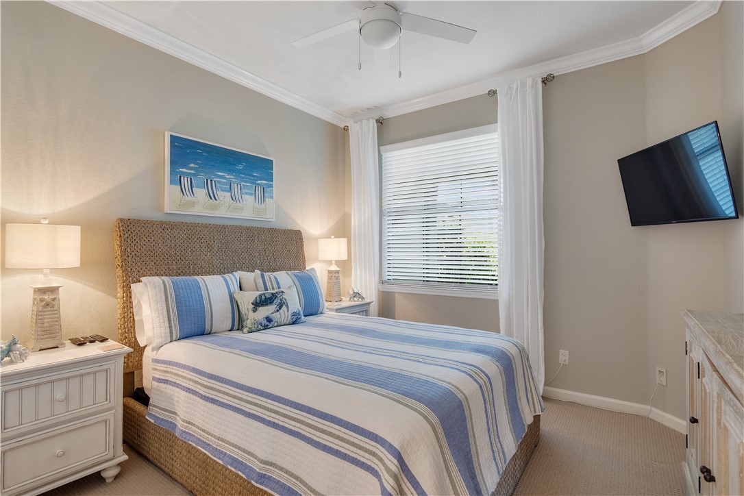 5122 Unity Square Vero Beach, FL 32967 - Photo 18 of 33 a bedroom with a large bed and a tv