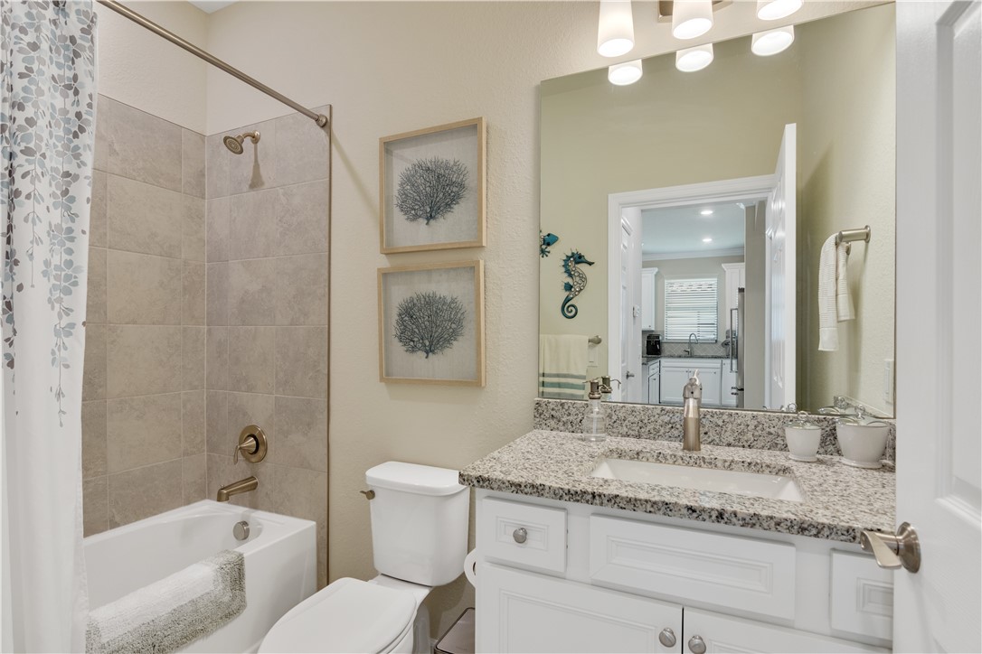 5122 Unity Square Vero Beach, FL 32967 - Photo 19 of 33 a bathroom with a granite countertop sink a toilet and shower