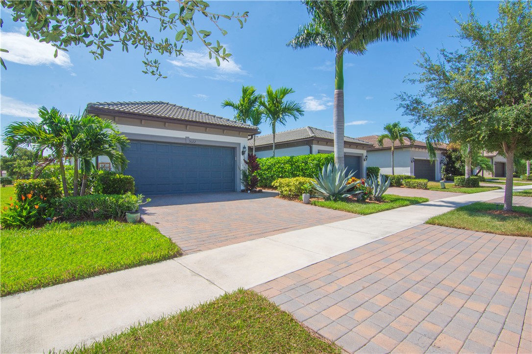 5122 Unity Square Vero Beach, FL 32967 - Photo 2 of 33 a front view of a house with garden